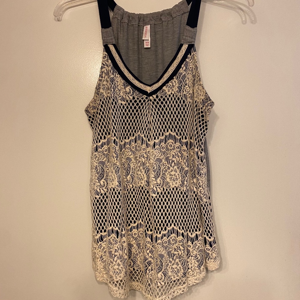 Lacy sleeveless blouse.